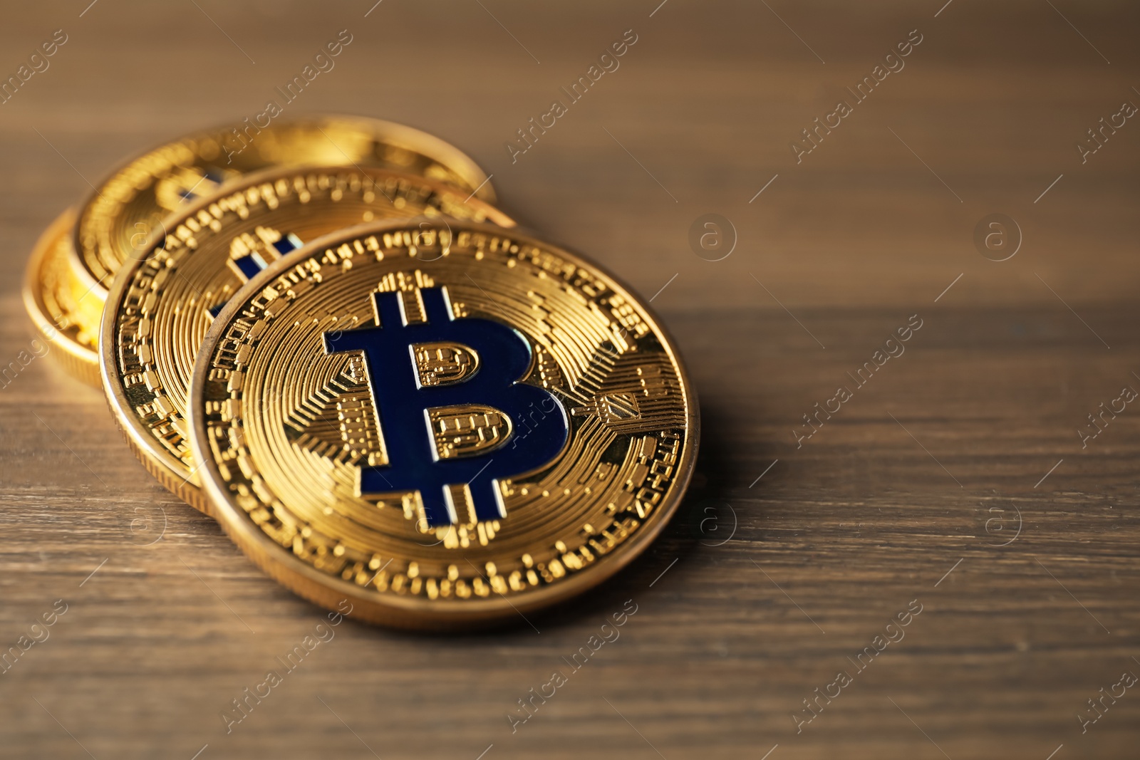Cryptocurrency. Many bitcoins on wooden table, closeup. Space for text Photo of Cryptocurrency. Many bitcoins on wooden table, closeup. Space for text