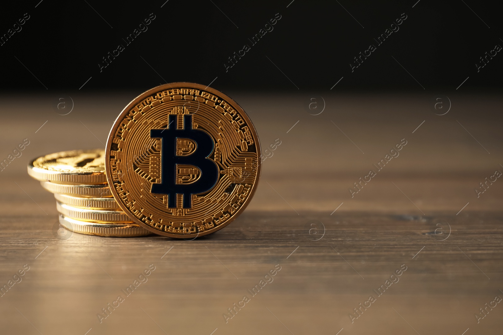Cryptocurrency. Many bitcoins on wooden table, closeup. Space for text Photo of Cryptocurrency. Many bitcoins on wooden table, closeup. Space for text