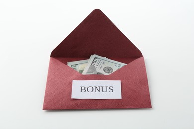 Photo of Envelope with word Bonus and dollar banknotes on white background