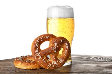 Photo of Tasty pretzels and glass of beer on wooden table against white background