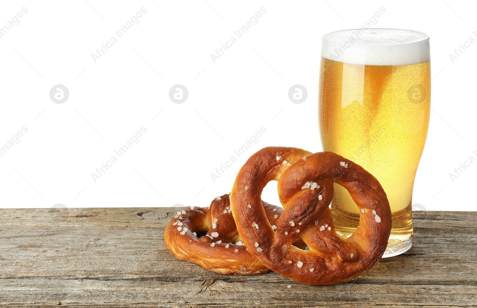 Tasty pretzels and glass of beer on wooden table against white background. Space for text Photo of Tasty pretzels and glass of beer on wooden table against white background. Space for text