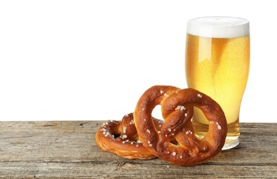 Photo of Tasty pretzels and glass of beer on wooden table against white background. Space for text