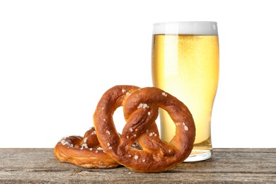 Photo of Tasty pretzels and glass of beer on wooden table against white background
