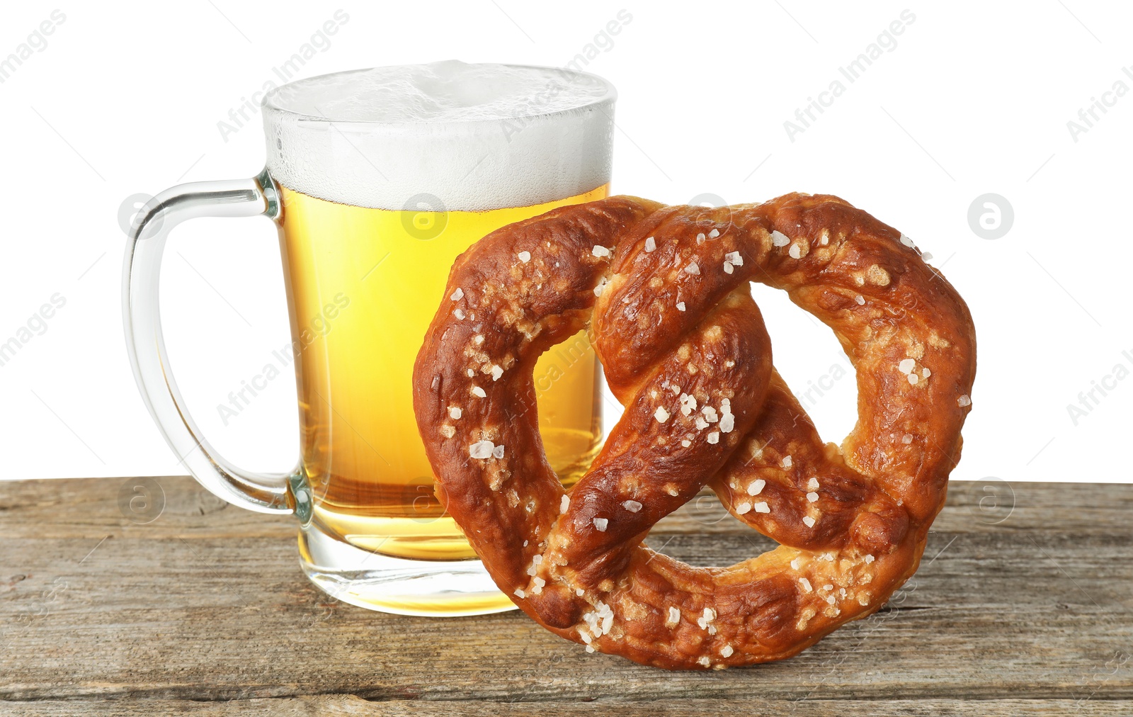 Tasty pretzel and glass of beer on wooden table against white background Photo of Tasty pretzel and glass of beer on wooden table against white background