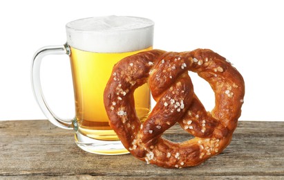 Photo of Tasty pretzel and glass of beer on wooden table against white background