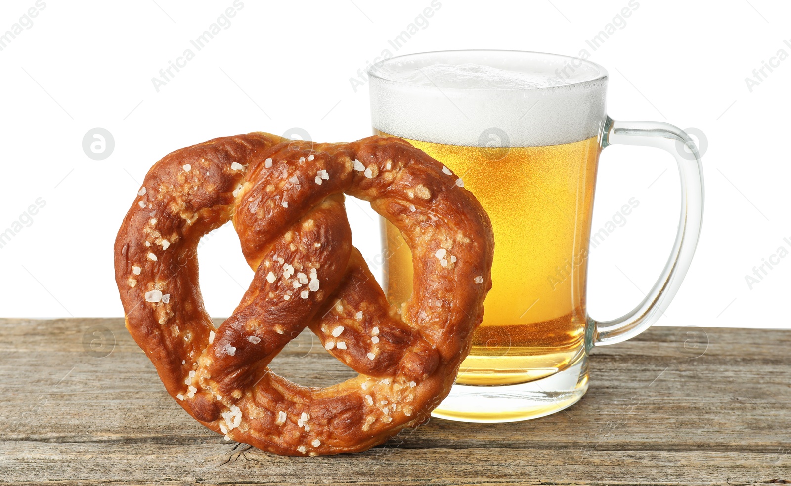 Tasty pretzel and glass of beer on wooden table against white background Photo of Tasty pretzel and glass of beer on wooden table against white background