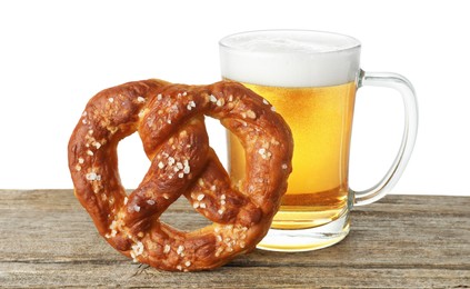 Photo of Tasty pretzel and glass of beer on wooden table against white background