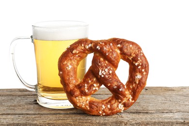 Photo of Tasty pretzel and glass of beer on wooden table against white background