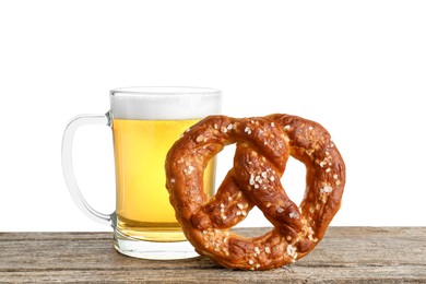 Photo of Tasty pretzel and glass of beer on wooden table against white background