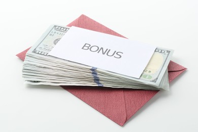 Photo of Envelope with word Bonus and dollar banknotes on white background