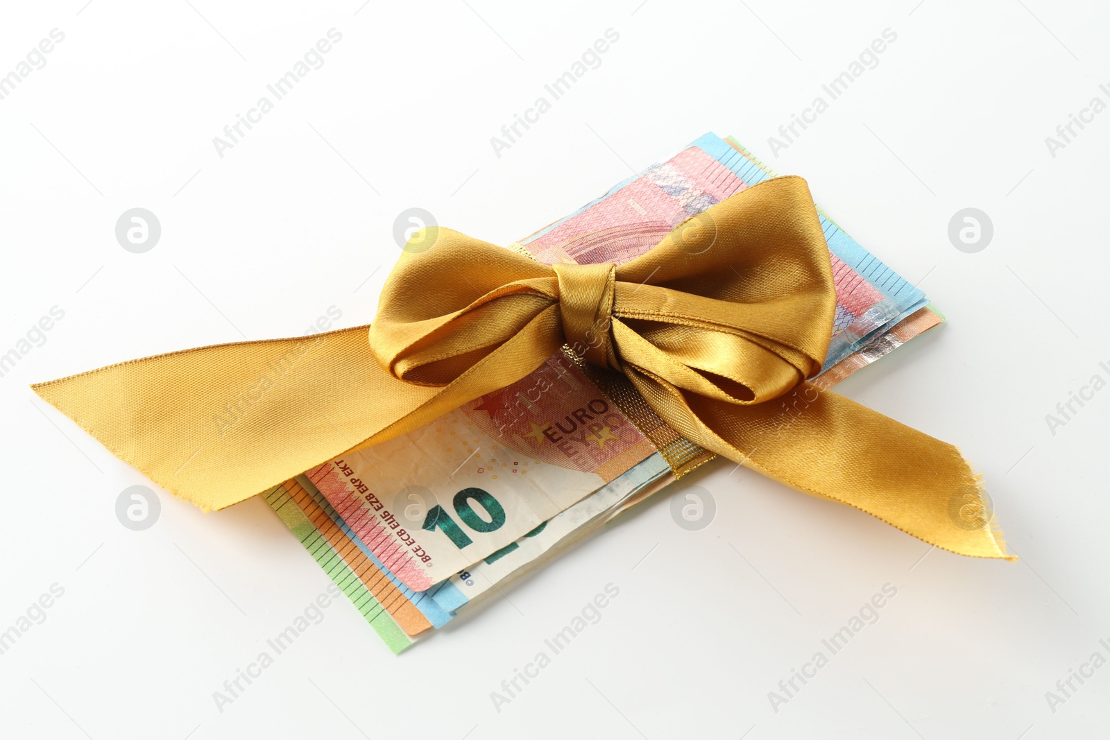 Money bonus. Euro banknotes with bow on white background Photo of Money bonus. Euro banknotes with bow on white background