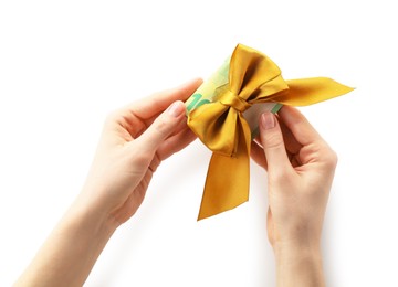 Photo of Money bonus. Woman holding euro banknotes with bow on white background, closeup