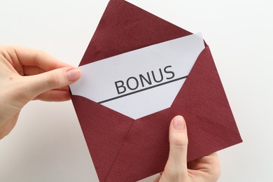 Photo of Woman holding envelope with word Bonus on white background, closeup