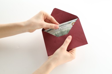 Photo of Money bonus. Woman holding envelope with dollar banknotes on white background, closeup