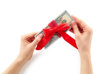 Photo of Money bonus. Woman holding dollar banknotes with bow on white background, closeup