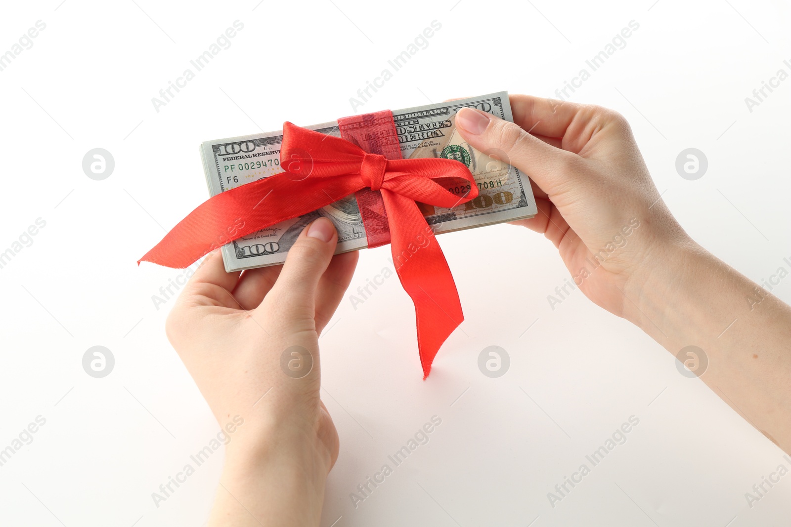 Money bonus. Woman holding dollar banknotes with bow on white background, closeup Photo of Money bonus. Woman holding dollar banknotes with bow on white background, closeup