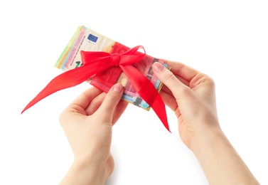 Photo of Money bonus. Woman holding euro banknotes with bow on white background, closeup