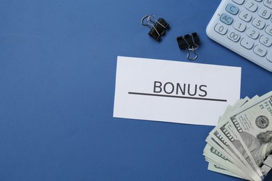 Photo of Card with word Bonus, money, calculator and clips on blue background, flat lay. Space for text