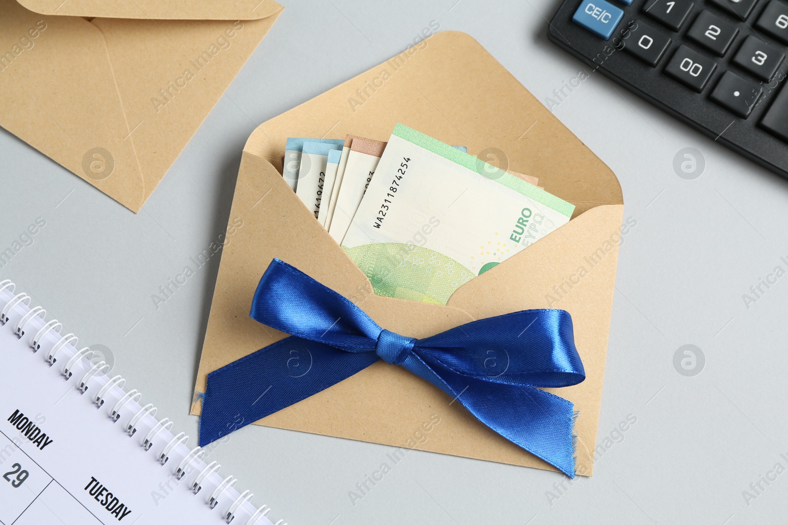 Money bonus. Envelope with euro banknotes on light grey background, flat lay Photo of Money bonus. Envelope with euro banknotes on light grey background, flat lay