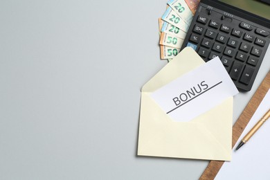 Photo of Card with word Bonus, money, clipboard and calculator on light grey background, flat lay. Space for text