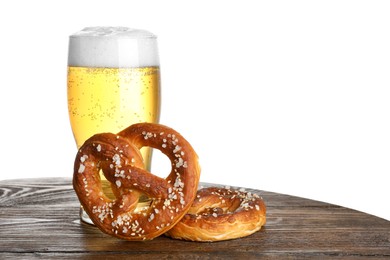 Photo of Tasty pretzels and glass of beer on wooden table against white background. Space for text