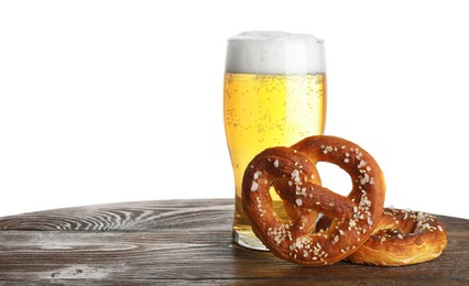 Photo of Tasty pretzels and glass of beer on wooden table against white background. Space for text