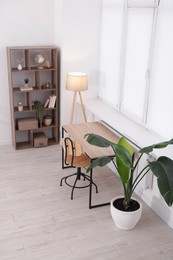 Photo of Stylish living room interior. Sofa, table, shelving unit and other furniture indoors, above view