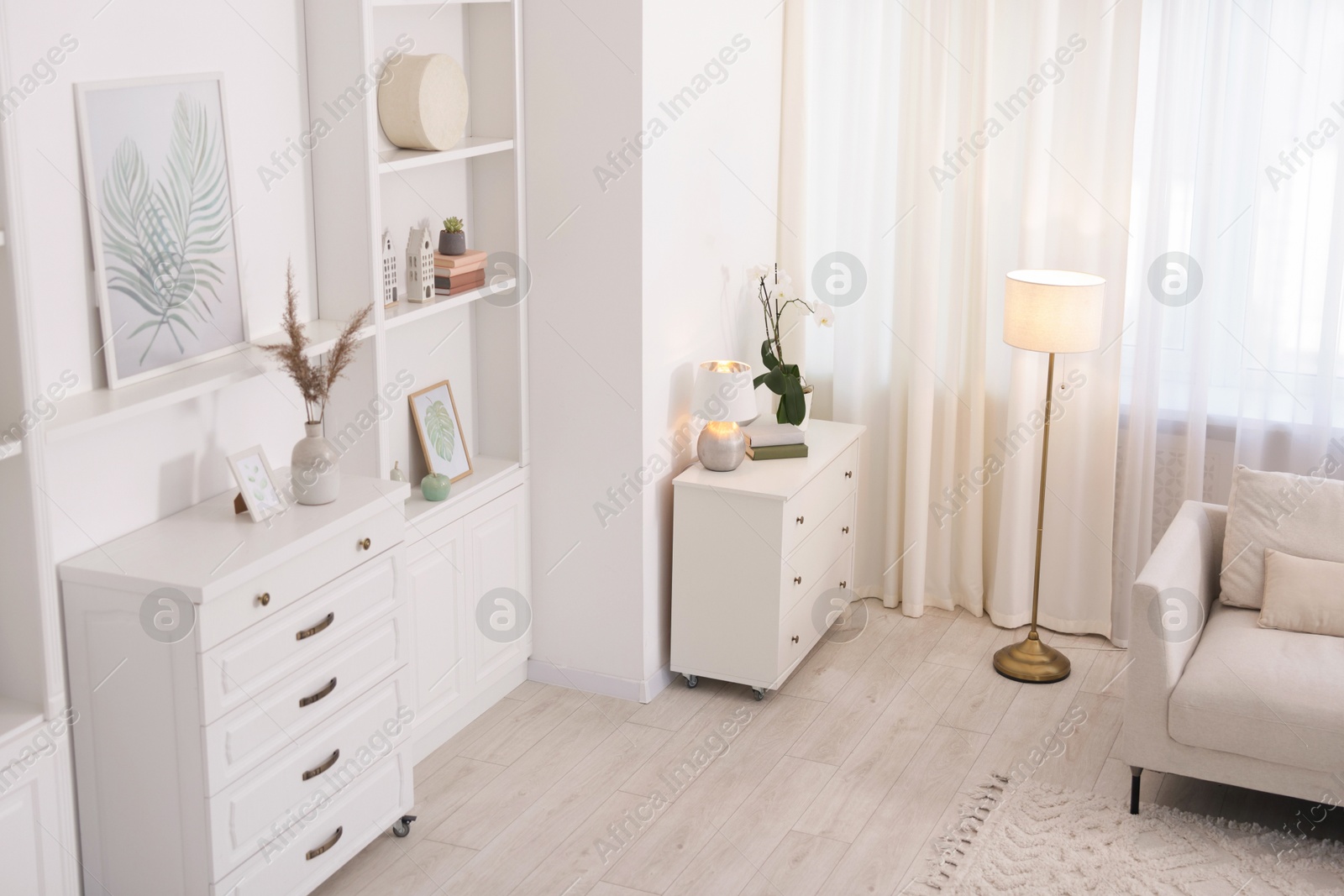 Stylish living room interior. Sofa, dresser, shelving unit and other furniture indoors, above view Photo of Stylish living room interior. Sofa, dresser, shelving unit and other furniture indoors, above view