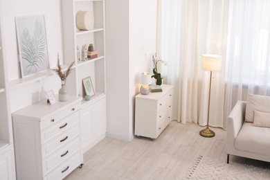 Photo of Stylish living room interior. Sofa, dresser, shelving unit and other furniture indoors, above view