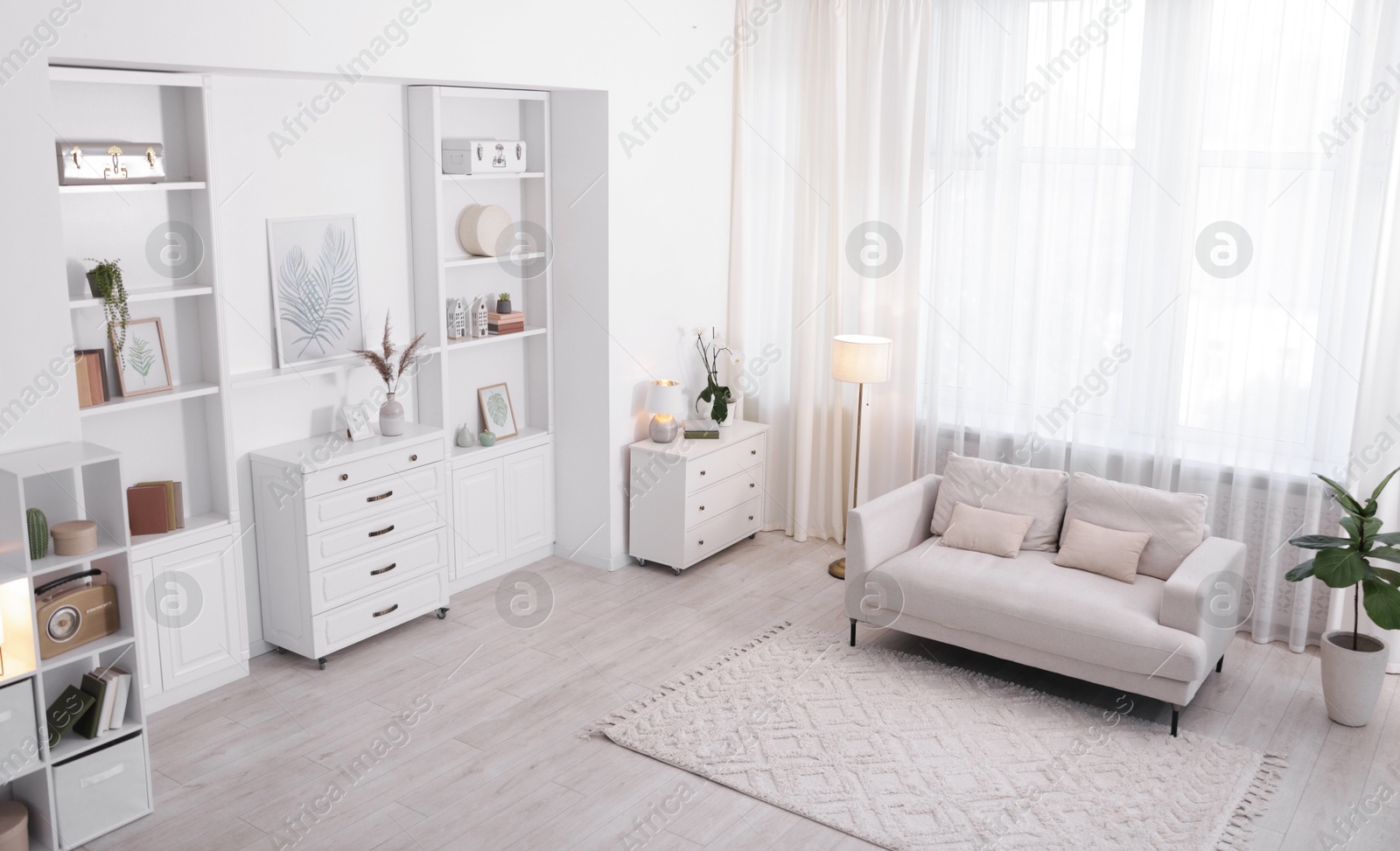 Photo of Stylish living room interior. Sofa, dresser, shelving unit and other furniture indoors, above view