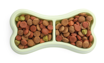 Photo of Dry pet food in feeding bowl isolated on white, top view