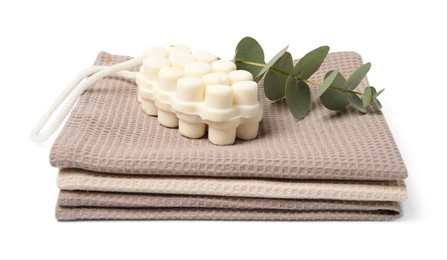 Photo of Clean waffle towels, soap and eucalyptus isolated on white
