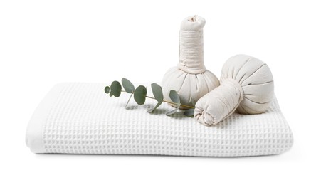Photo of Clean waffle towel, massage bags and eucalyptus isolated on white