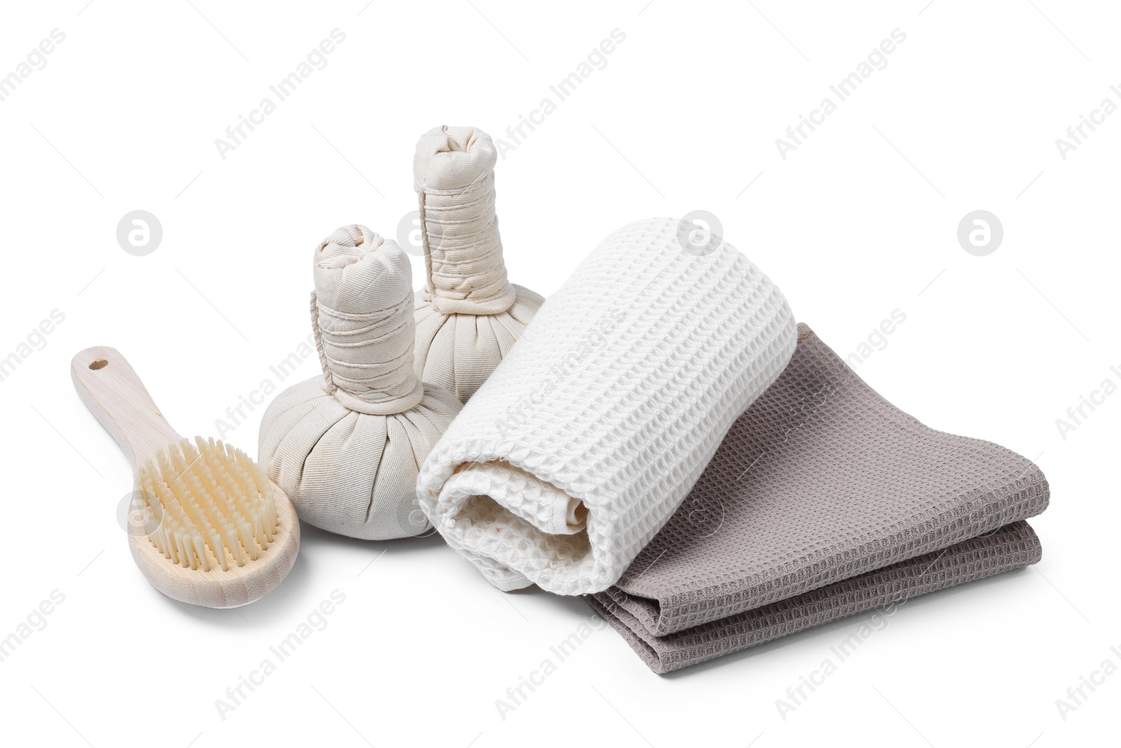 Clean waffle towels, massage bags and brush isolated on white Photo of Clean waffle towels, massage bags and brush isolated on white