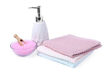 Photo of Clean waffle towels, soap and sea salt isolated on white