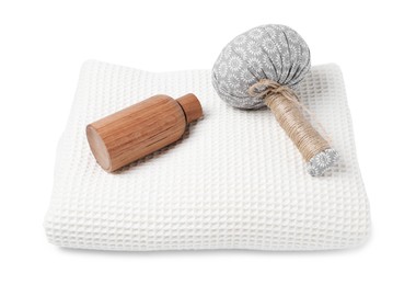 Photo of Clean waffle towel, cosmetic product and massage bag isolated on white