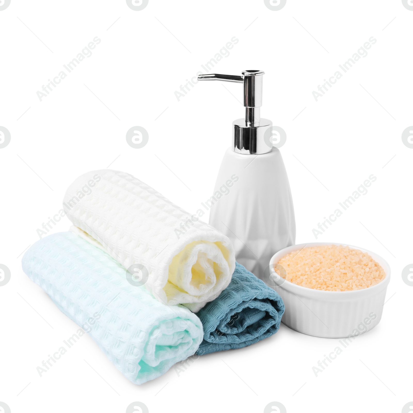 Clean waffle towels, sea salt and soap isolated on white Photo of Clean waffle towels, sea salt and soap isolated on white