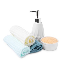 Photo of Clean waffle towels, sea salt and soap isolated on white