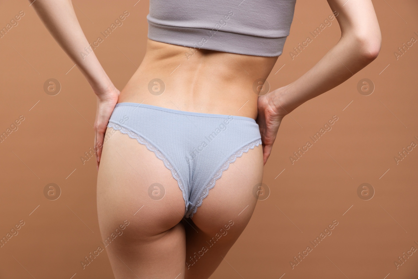 Woman wearing beautiful underwear on brown background, closeup Photo of Woman wearing beautiful underwear on brown background, closeup