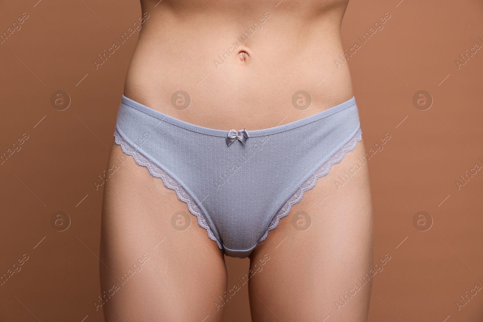 Woman wearing beautiful underwear on brown background, closeup Photo of Woman wearing beautiful underwear on brown background, closeup