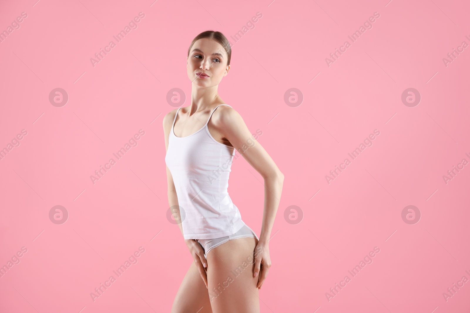 Woman wearing beautiful underwear on pink background Photo of Woman wearing beautiful underwear on pink background