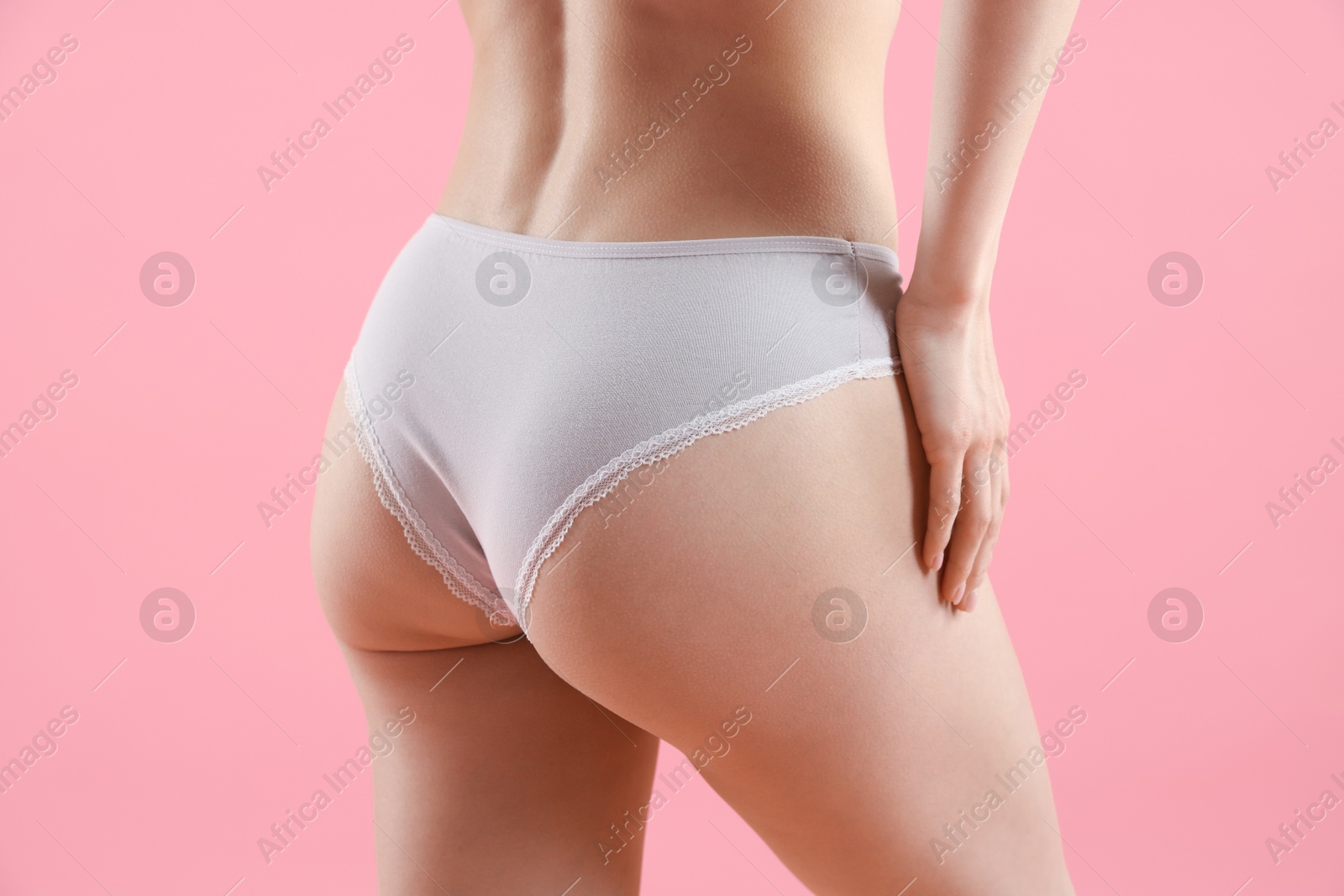 Woman wearing beautiful underwear on pink background, closeup Photo of Woman wearing beautiful underwear on pink background, closeup