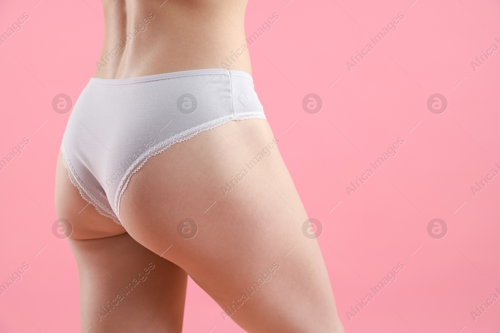 Woman wearing beautiful underwear on pink background, closeup. Space for text Photo of Woman wearing beautiful underwear on pink background, closeup. Space for text