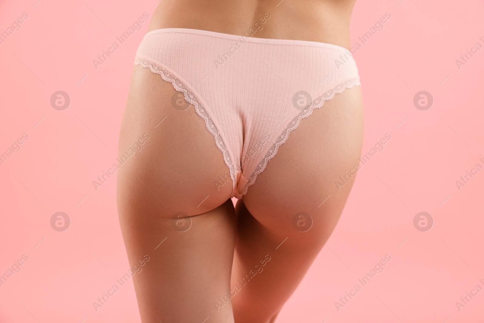 Woman wearing beautiful underwear on pink background, closeup Photo of Woman wearing beautiful underwear on pink background, closeup