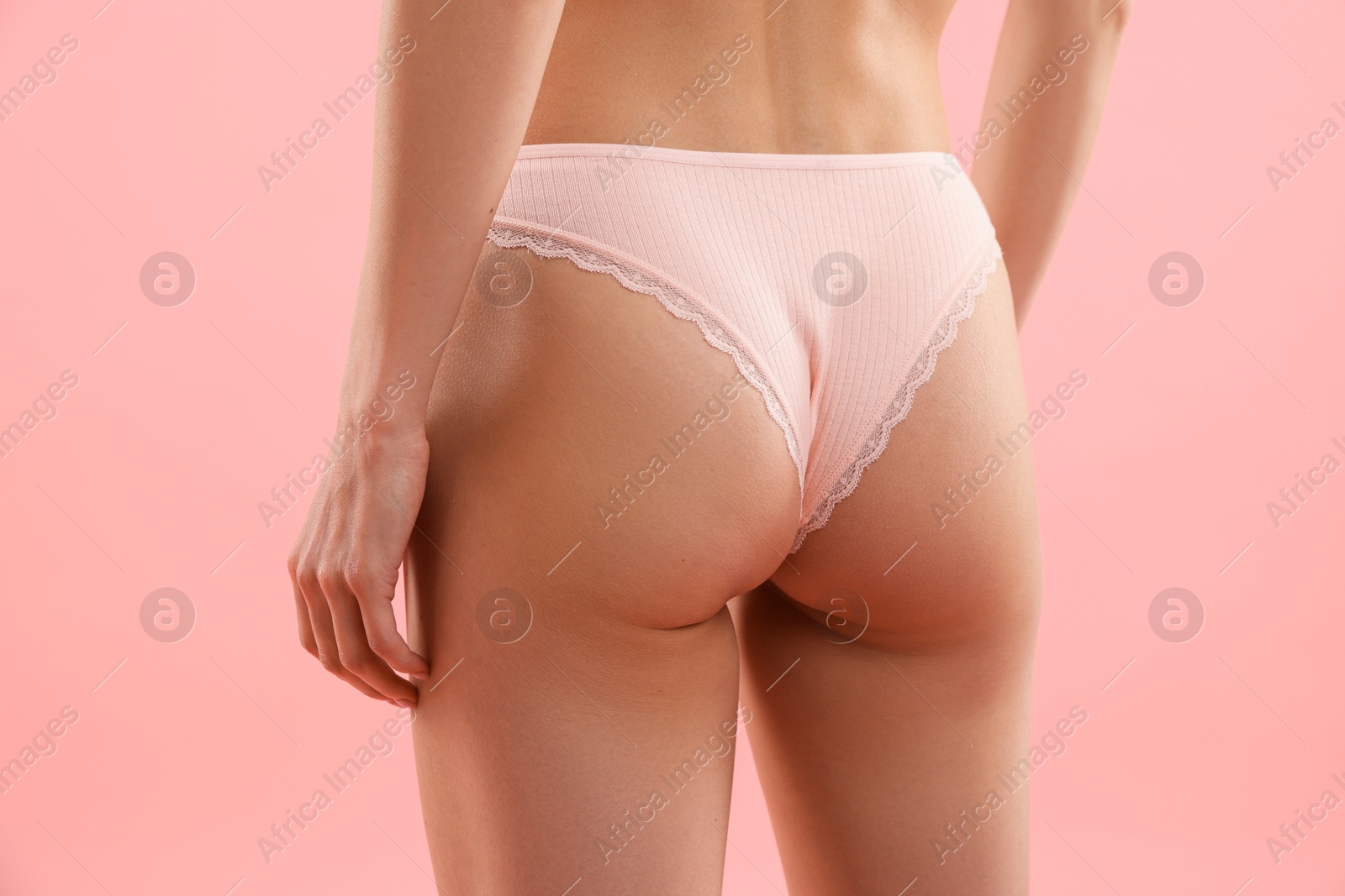 Woman wearing beautiful underwear on pink background, closeup Photo of Woman wearing beautiful underwear on pink background, closeup