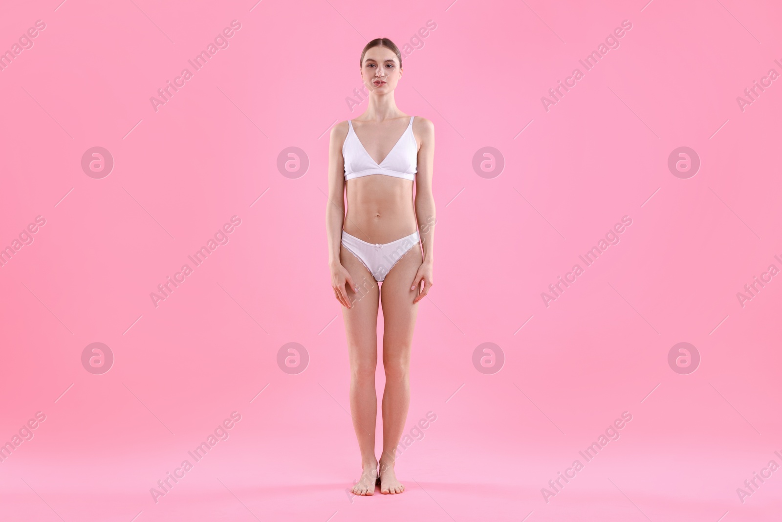 Woman wearing beautiful underwear on pink background Photo of Woman wearing beautiful underwear on pink background