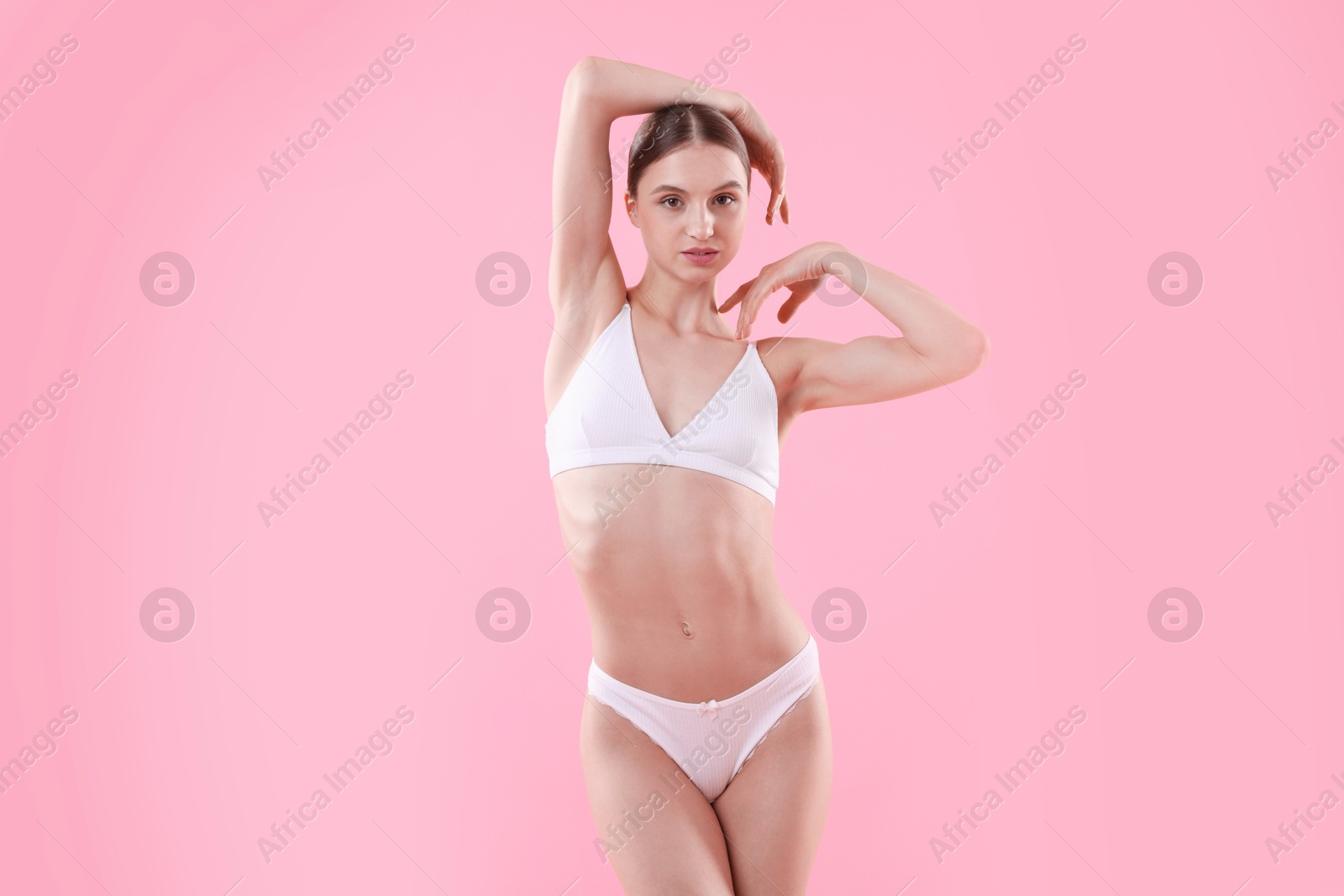 Woman wearing beautiful underwear on pink background Photo of Woman wearing beautiful underwear on pink background