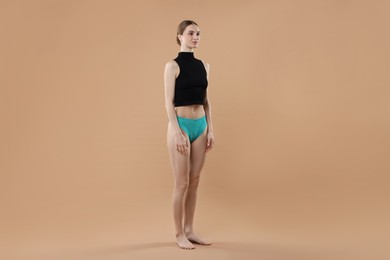 Photo of Woman wearing beautiful underwear on beige background