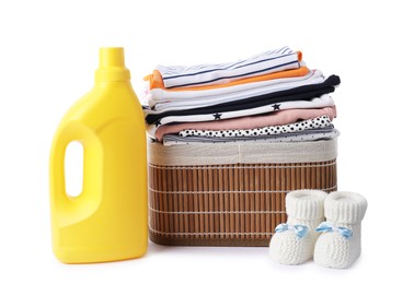 Photo of Bottle with fabric softener, shoes and baby clothes isolated on white