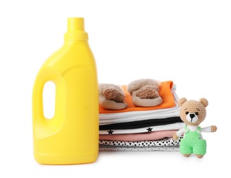 Photo of Bottle with fabric softener, shoes, baby clothes and toy isolated on white